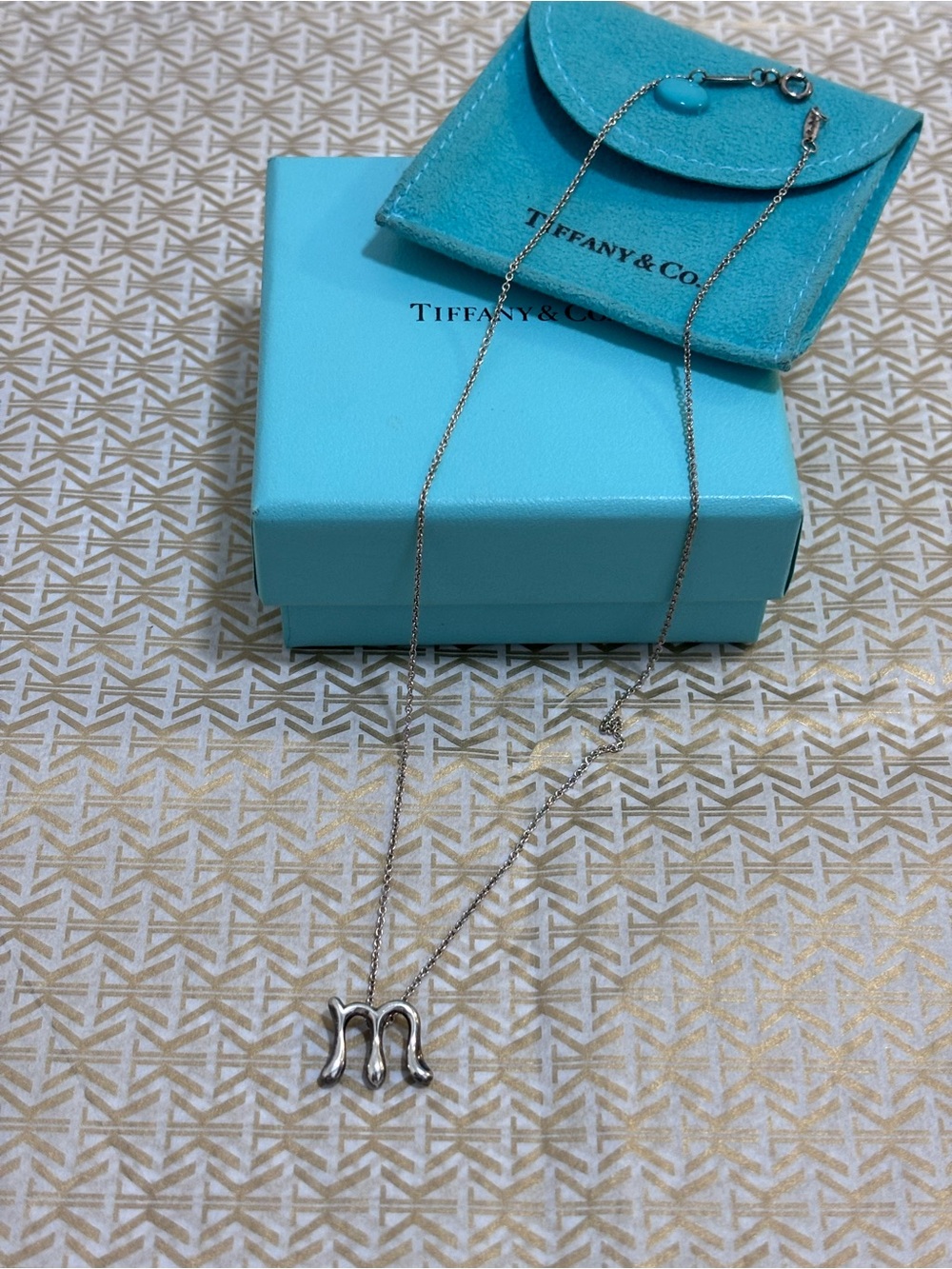 Tiffany & Co. Silver 925 “M” Initial Necklace
Elsa Peretti with pouch and Box